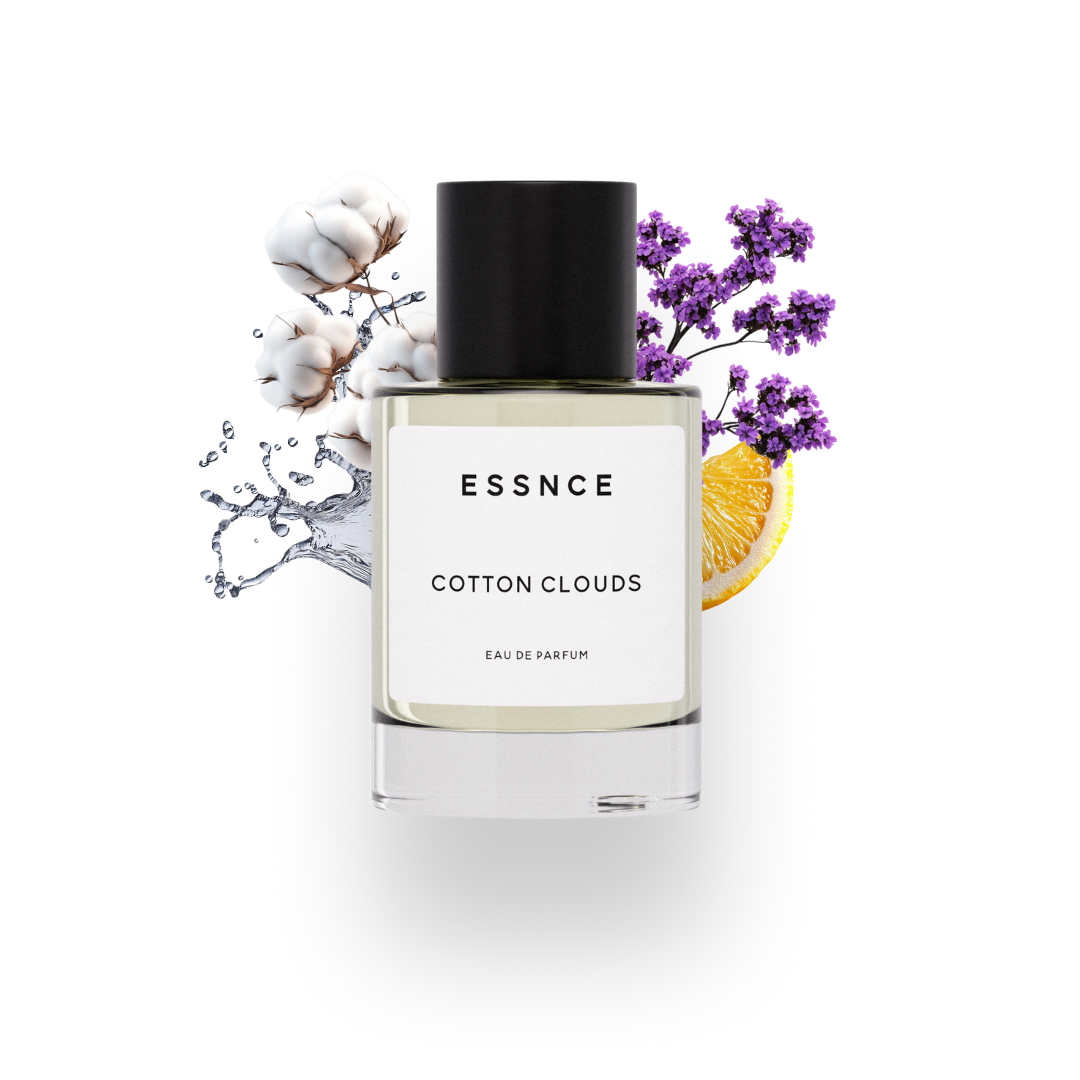 A perfume bottle labeled ESSNCE Cotton Clouds is displayed with artistic elements. The background features lavender sprigs, cotton blossoms, a slice of orange, and water splashes, highlighting the fragrance ingredients of the product.